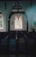 A glum gaze through a window reveals a practical interior.